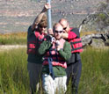 Photo of Christiaan King, Jay White and Brian Chase carrying a sediment core.