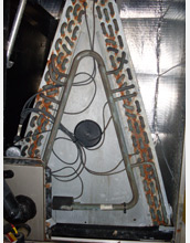 Photo showing corrosion and damage to copper components in an air handling system.