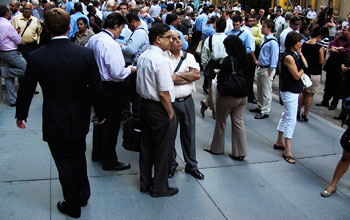 Photo of a crowd of people outside New York's Wall Street.