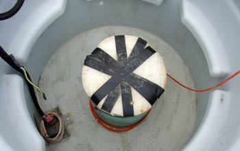 the seismometer wrapped in insulating material at the bottom of the vault.