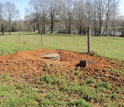 Photo  of a vault containing the tightly sealed seismometer and electronics and covered with dirt.