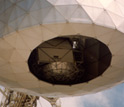 Photo showing the inside the dome of the Arecibo Observatory, where there is a pulsar detector.