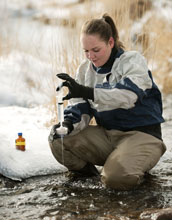 Photo of University of Wyoming student Sarah Ann Gregory gathering water samples for research.