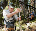 Photo of University of Wyoming Associate Professor Scott Miller measuring streamflow in a creek.