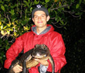 Photo of scientist Adam Rosenblatt holding a young American alligator.