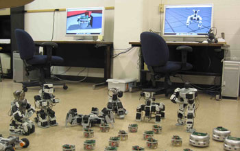 Photo of two computers and a terrestrial robot swarm