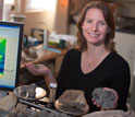 Photo of scientist Alycia Stigall on the right and a computer monitor on the left.