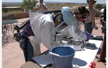 Photo showing biologists collecting blood samples from rodents to test for Hantavirus.