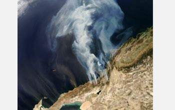 Satellite image of smoke from Southern California wildfires billowing over the Pacific Ocean.