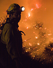 Photo of a firefighter fighting a wildfire