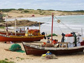 Photo of fishing boats lining the beach at Punta del Diablo, Uruguay.