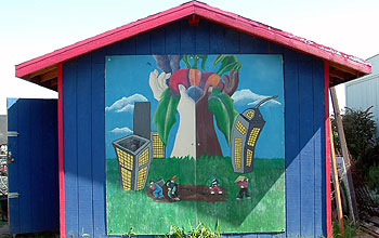 Colorful toolshed mural inside garden.