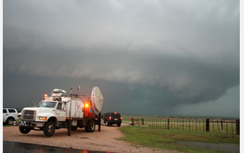 Photo of geoscientists using Doppler-on-Wheels to study tornado formation.