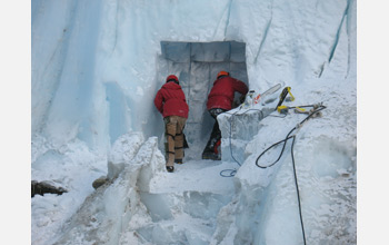 Photo of two people excavating a sampling tunnel into Taylor Glacier.