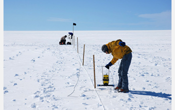 Photo of researchers collecting radar data to document meltwater movement on the Ice Sheet.