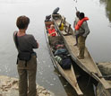 Students with equipment and boats on the Ogooué river in Gabon