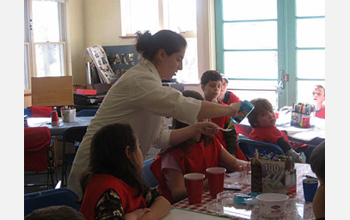 Photo of Susannah Gordon-Messer demonstrating how to make slime.