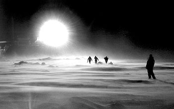 A team of seal researchers works in by the light of the research vessel Laurence M. Gould.