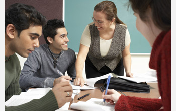 Photo of graduate students seated around a table.