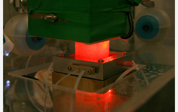 Photo of a Greenland ice core sitting on a melter head in the research facility.