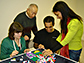 Photo of a a team working on one of the tasks used in the study involving Legos.