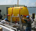Photo of autonomous underwater vehicle Sentry being loaded onto a vessel.