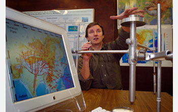 Geophysicist Eric Calais holds a geodetic marker that tracks even very small Earth movements.