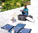 Louis Obenson of Haiti's Civil Protection Agency installs GPS equipment in Port-au-Prince.