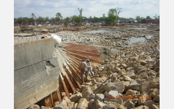 Engineers inspect a portion of a New Orleans floodwall damaged in Hurricane Katrina