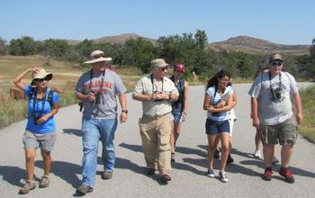 Students and professors walking on a road between hills