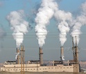 image of power plant with smoking chimneys