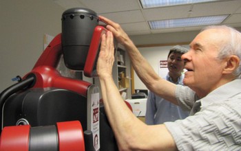 a man interacts with a robot