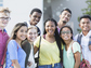 A group of teenagers smile at the camera.