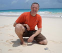 Photo of Rob Condon in Bermuda with Portuguese Man-o-War jelly washed up on beach.