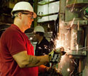 engineer Dan Slobodzian grinding rough edges on a CORK observatory before its installation.