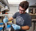 microbiologist Joe Russell examining samples in the lab onboard the JOIDES Resolution.