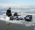 Researcher James McClelland sampling water during ice break-up in Kaktovik Lagoon, Alaska.
