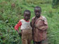 Photo of two children at the edge of Kibale National Park, Uganda.