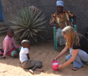 Scientist Kathleen Alexander with locals in a yard in a Botswana village.