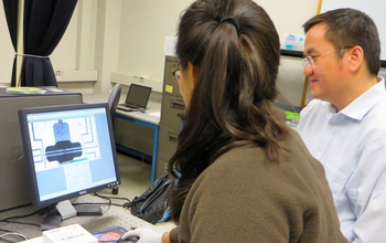 Li Shi and graduate student, Gabriel Coloyan at a computer exploring germanane.