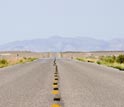 Photo of a paved road in a valley in the Great Basin.