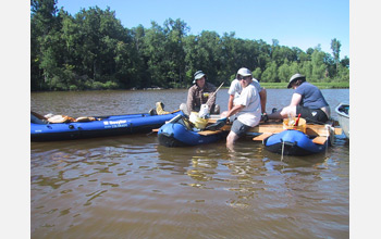 Photo of researchers collecting a sediment core from Silver Lake,
Ohio.