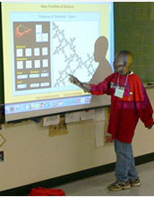 Photo of a middle-school student describing a mathematical image on a screen.