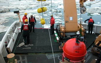 Researchers deploy Mooring flotation balls during a research expedition.