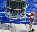 Photo showing marine scientists obtaining ocean water samples aboard a research vessel.