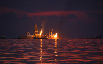 Photo showing flares of captured gas and oil at the Deepwater Horizon spill site in June 2010.