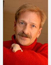 Photo of Thomas Park with a naked mole-rat on his sleeve.