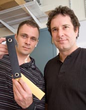 Photo of Cornell University researchers holding up a double pendulum.