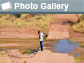 Image of Kyle Nichols viewing a wet river crossing with words Photo Gallery and photo icon.