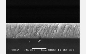 Cross-sectional view of a cadmium telluride thin film on glass via a scanning electron microscope.